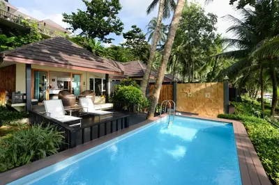 a swimming pool in the backyard of a villa at Andaman White Beach Resort - SHA Plus in Nai Thon Beach