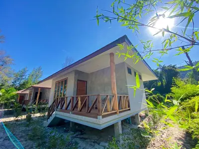a small house with a balcony in a forest at Koh Yao Beach Front in Ko Yao Yai
