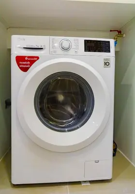 a white washing machine sitting in a room at Oceanstone by Holy Cow, 1-BR, next building view in Bang Tao Beach