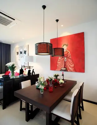 a dining room with a table and a painting on the wall at Two Villas HOLIDAY - ONYX Style Naiharn Beach, Phuket in Nai Harn Beach