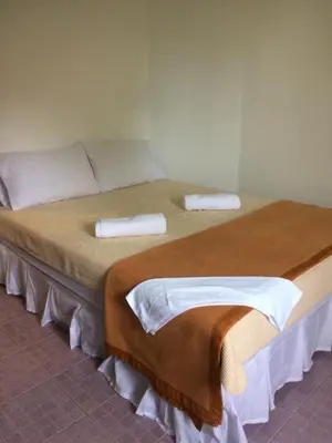a bedroom with two beds with towels on them at Hero Phuket in Nai Yang Beach