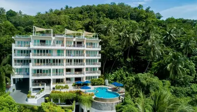 an aerial view of a resort with a pool and trees at The Park Surin Serviced Apartments by RESAVA in Surin Beach