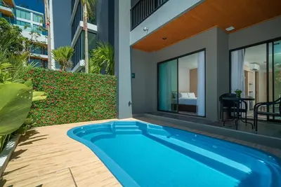a swimming pool in front of a house at Grand Kata VIP - Kata Beach in Kata Beach