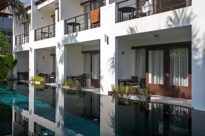 an external view of a building with a swimming pool at Tea Tree Boutique Resort in Rawai Beach