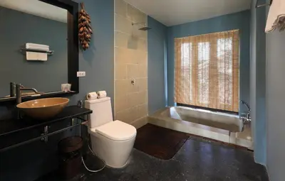 a bathroom with a sink and a toilet and a tub at Tea Tree Boutique Resort in Rawai Beach