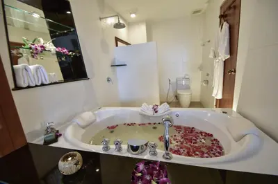 a bathroom with a sink with flowers in it at Layalina Hotel in Kamala Beach