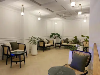 a waiting room with chairs and tables and plants at L'esprit De Naiyang Beach Resort - SHA Extra Plus in Nai Yang Beach