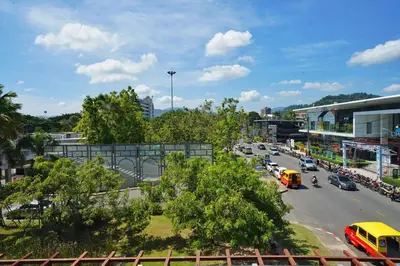 a busy street in a city with cars on the road at Baan Suwantawe in Phuket Town