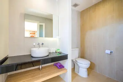 a bathroom with a sink and a toilet at Baan Suwantawe in Phuket Town