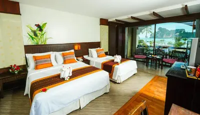 a hotel room with two beds and a balcony at Phi Phi Island Cabana Hotel in Phi Phi Don