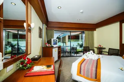 a hotel room with a bed and a desk with a table at Phi Phi Island Cabana Hotel in Phi Phi Don