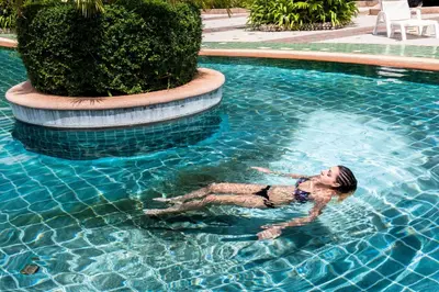 a woman swimming in a swimming pool in a swimming pool at Phi Phi Island Cabana Hotel in Phi Phi Don