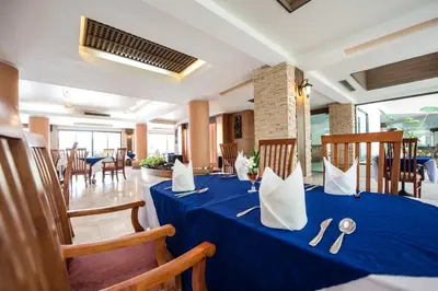 a blue table with napkins and utensils on it at Phi Phi Island Cabana Hotel in Phi Phi Don