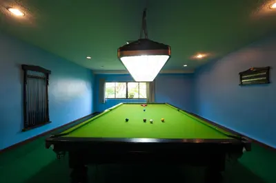 a pool table in a room with a light at Phi Phi Island Cabana Hotel in Phi Phi Don