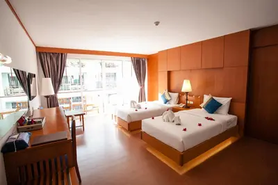 a hotel room with two beds and a desk at Phi Phi Harbour View Hotel in Phi Phi Don