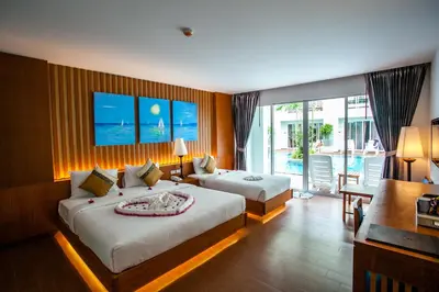 a hotel room with two beds and a balcony at Phi Phi Harbour View Hotel in Phi Phi Don