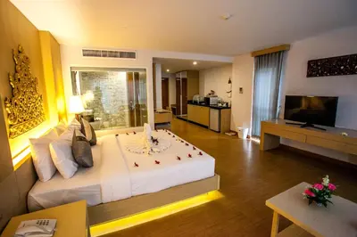 a hotel room with a large bed and a television at Phi Phi Harbour View Hotel in Phi Phi Don