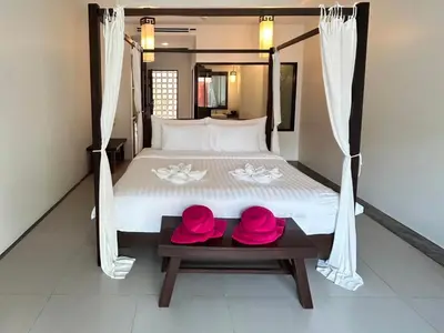 a bed with two pink hats on a table at Phuketa Hotel Phuket Town in Phuket Town