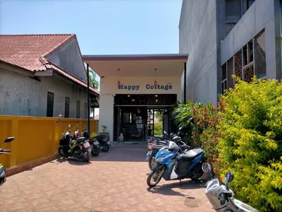 a group of motorcycles parked in front of a building at Happy Cottage in Chalong