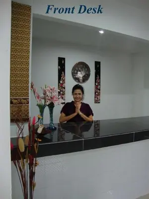 a man sitting at a counter in front of a mirror at G&B Guesthouse in Patong Beach
