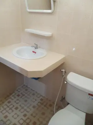 a bathroom with a white sink and a toilet at G&B Guesthouse in Patong Beach