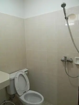 a bathroom with a toilet and a shower at G&B Guesthouse in Patong Beach