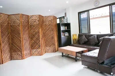 a living room with a couch and a table at G&B Guesthouse in Patong Beach