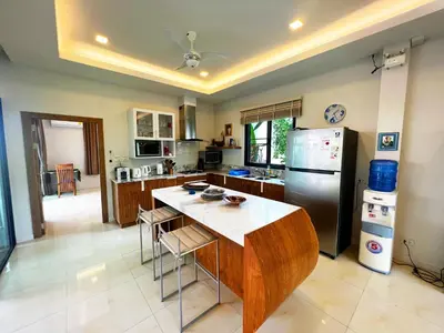 a kitchen with a refrigerator and a table in it at Cozy Two Bedrooms Villa by G Estate in Rawai Beach
