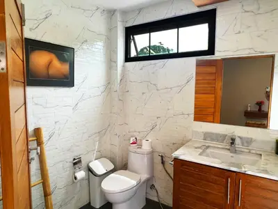 a bathroom with a toilet and a sink and a window at Cozy Two Bedrooms Villa by G Estate in Rawai Beach