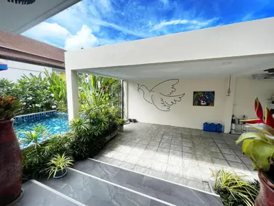 an open patio with a bird stencil on the wall at Cozy Two Bedrooms Villa by G Estate in Rawai Beach
