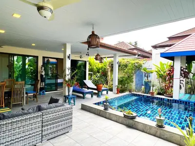 a house with a swimming pool in a yard at Cozy Two Bedrooms Villa by G Estate in Rawai Beach