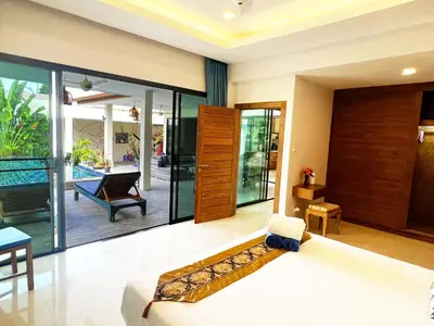 a bedroom with a bed and a view of a pool at Cozy Two Bedrooms Villa by G Estate in Rawai Beach