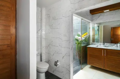 a bathroom with a toilet and a sink and a mirror at Nenuphar Villa by G Estate in Rawai Beach