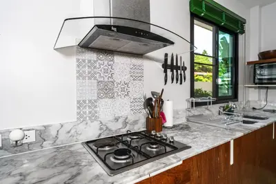 a kitchen with a stove and a counter top at Nenuphar Villa by G Estate in Rawai Beach