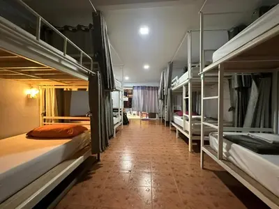 a hallway with several bunk beds in a room at Hangover Hostel in Phi Phi Don