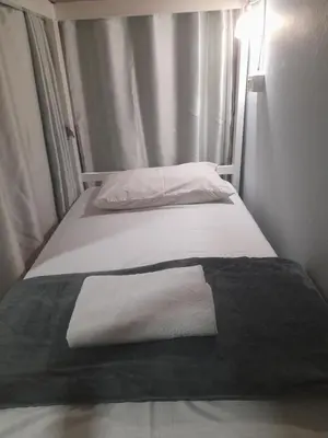 two beds in a room with two white towels on them at Hangover Hostel in Phi Phi Don