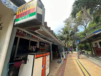 a store with a sign on the side of a street at Hangover Hostel in Phi Phi Don