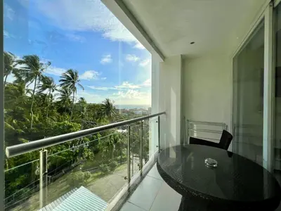 a balcony with a table and a view of the city at Sunset Plaza by RESAVA in Karon Beach
