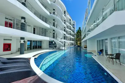 a swimming pool in the middle of a building at Sunset Plaza by RESAVA in Karon Beach