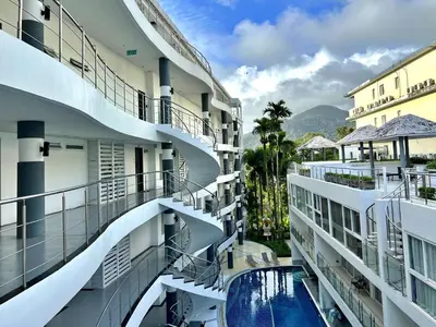 arial view of a building with a swimming pool at Sunset Plaza by RESAVA in Karon Beach