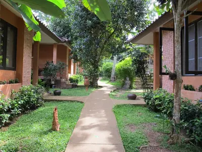a walking path in front of a building at Flora Ville-SHA PLUS in Chalong