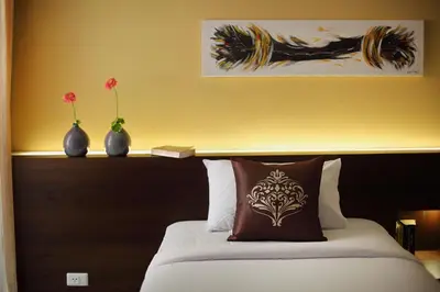 a bedroom with a bed with two vases on it at Samkong Place in Phuket Town