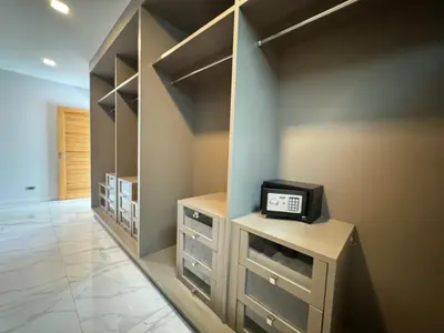 a walk in closet with a clock on a counter at Skypool Villa by G Estate Phuket in Nai Harn Beach