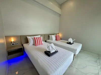 two beds in a room with towels on them at Skypool Villa by G Estate Phuket in Nai Harn Beach