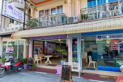 a store front of a building with tables and chairs at Grand Orchid Inn Patong beach in Patong Beach