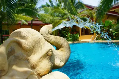 a statue of an elephant spitting water into a pool at Le Piman Resort in Rawai Beach