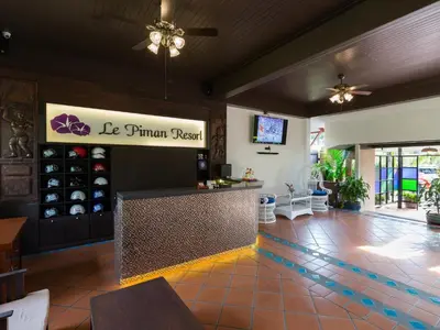 a restaurant with a bar in the middle of a room at Le Piman Resort in Rawai Beach