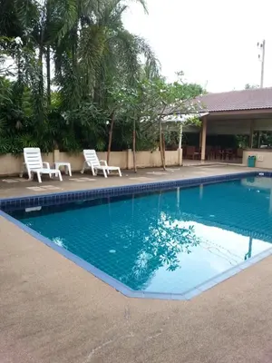a swimming pool with two white chairs next to it at C.A.P Mansion in Phuket Town