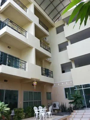 a building with tables and chairs in front of it at C.A.P Mansion in Phuket Town