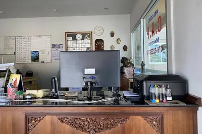 a desk with a computer on top of it at C.A.P Mansion in Phuket Town